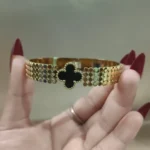 Black and gold clover bangle bracelet