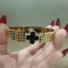 Black and gold clover bangle bracelet